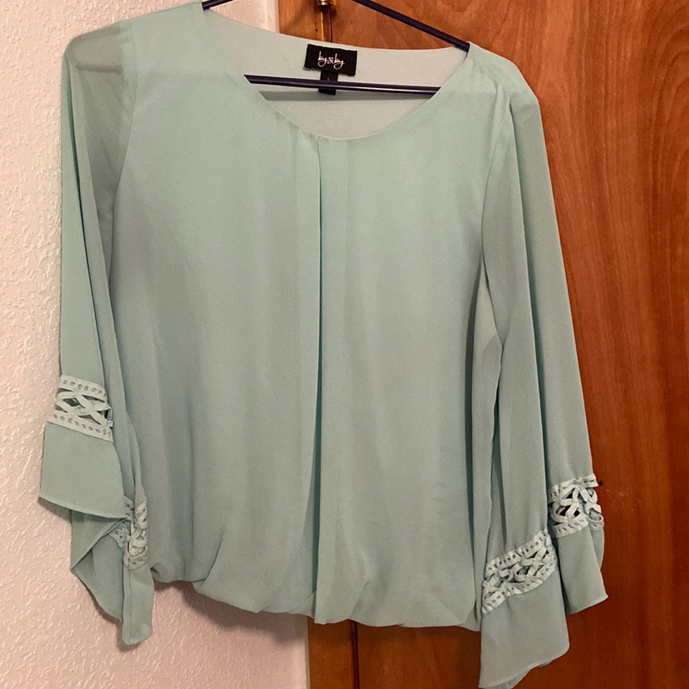 Light green long sleeve top.